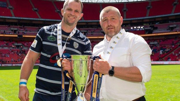 Fev skipper James Lockwood and assistant coach Paul March show off the 1895 Cup at Wembley