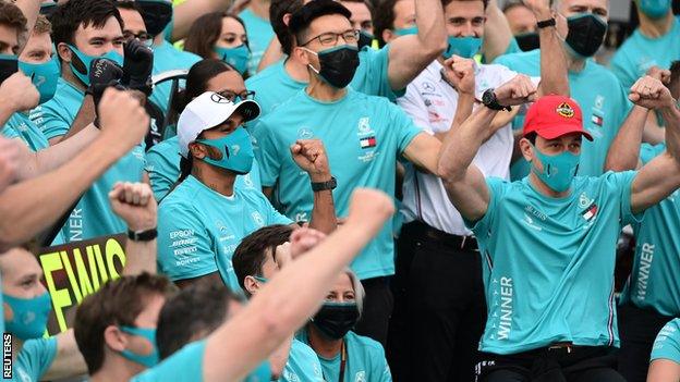 Lewis Hamilton and Toto Wolff celebrate with the Mercedes team