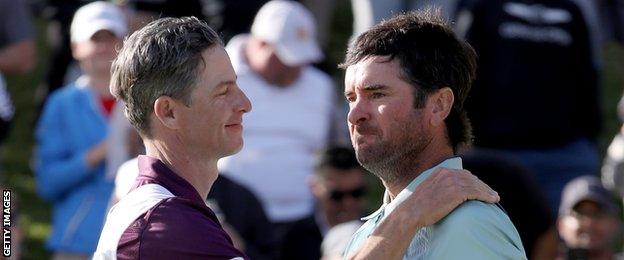 Bubba Watson and caddie Ted Scott celebrate after winning the Genesis Open