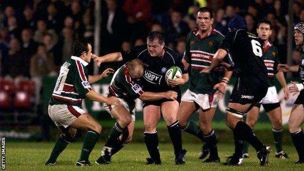 Andrew Millward of Neath is tackled by Neil Back of Leicester during the Heineken Cup match between Neath and Leicester Tigers at The Gnoll on October 11, 2002.