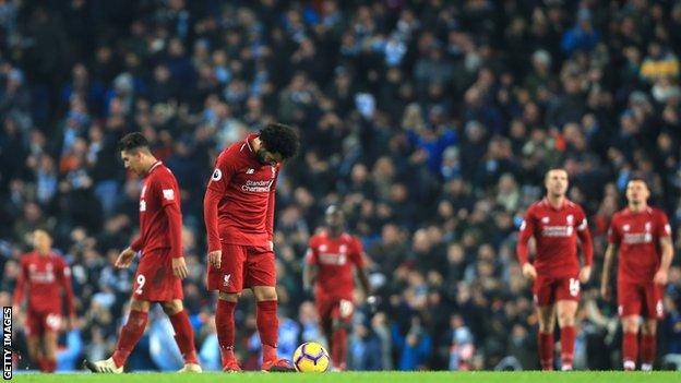 Liverpool players look dejected at the Etihad Stadium