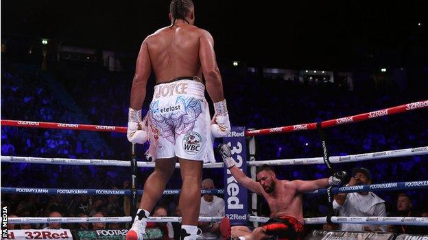 Joe Joyce stands over Joseph Parker