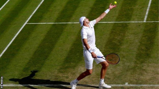 John Isner serves