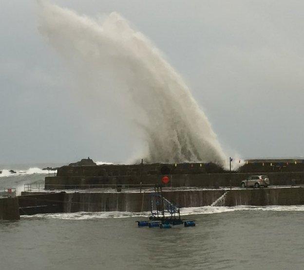 Huge spray of water rises above the promenade