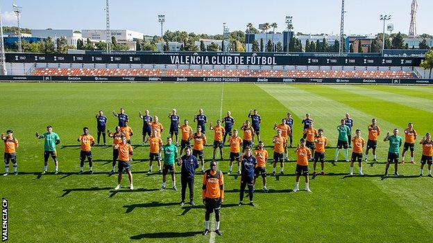 Valencia players pose for photo alongside Diakhaby