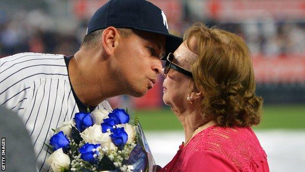 Rodriquez kisses his mother during a presentation ceremony