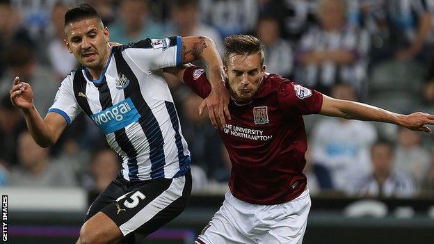 Northampton's Lawson D'Ath battles with Newcastle's £13m summer signing Aleksandar Mitrovic