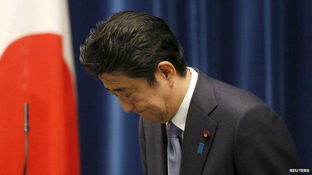 Japan's Prime Minister Shinzo Abe bows as he leaves a news conference after delivering a statement marking the 70th anniversary of World War Two's end, at his official residence in Tokyo, 14 August 2015