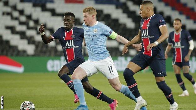 Kevin de Bruyne, Idrissa Gueye and Kylian Mbappe compete for the ball during the Champions League semi-final