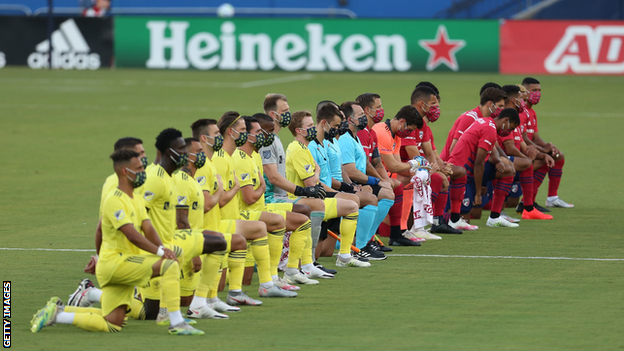 Dallas and Nashville players kneel during the national anthem