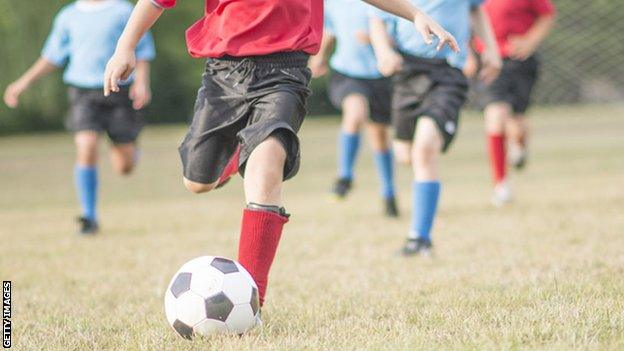 children playing football