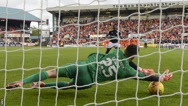 Harry Lewis saves Roarie Deacon's penalty