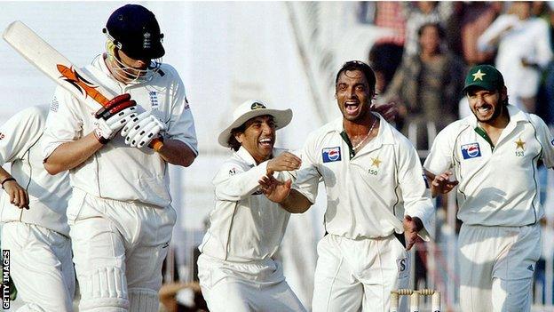 Pakistani cricketer Shoaib Akhtar celebrates with his teammate Shahid Afridi and Younis Khan after taking the wicket off England batsman Andrew Flintoff during the fifth and final day of the second Test match between Pakistan and England at the Iqbal Cricket Stadium in Faisalabad in 2005