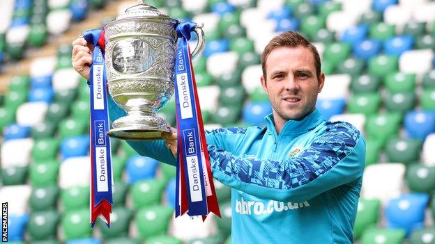 Jamie Mulgrew lifts the Gibson Cup