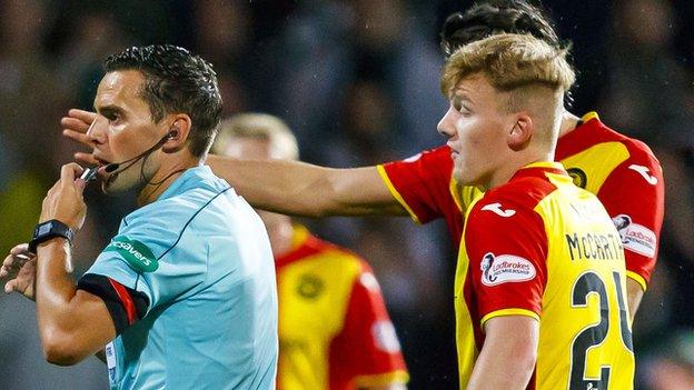 artick Thistle's players protest a late decision to not award them a penalty