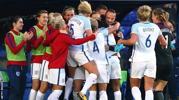 England players embrace Mark Sampson after the opening goal against Russia last month