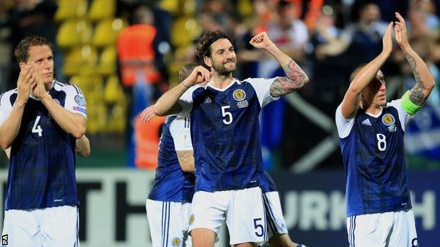 Scotland's Christophe Berra, Charlie Mulgrew and Scott Brown celebrate in Vilnius