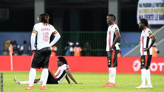 Uganda players look dejected after the defeat by Egypt