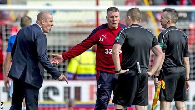 Mark Warburton speaks to officials