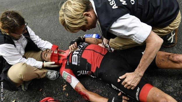 Richie Porte receives treatment after crashing out of the Tour de France