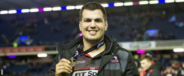 Stuart McInally shows off a man-of-the-match medal for Edinburgh