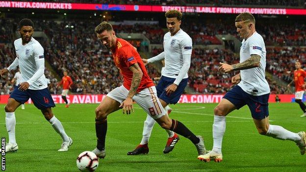 Spain midfielder Saul Niguez vies with England's defender Joe Gomez (left), England's midfielder Dele Alli (centre) and England's defender Kieran Trippier (right)