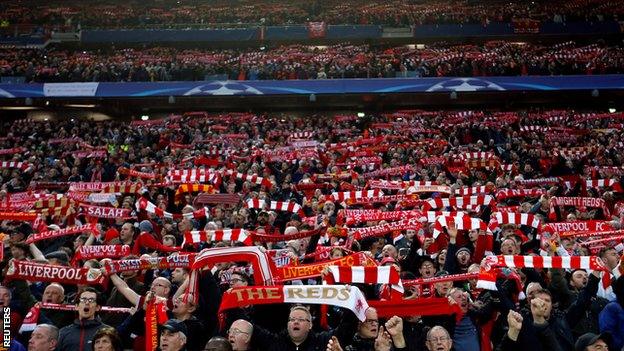 Liverpool fans hold aloft scarves at Anfield