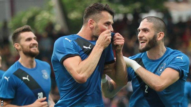 Albert Bunjaku (centre) of Kosovo celebrates scoring the opening goal