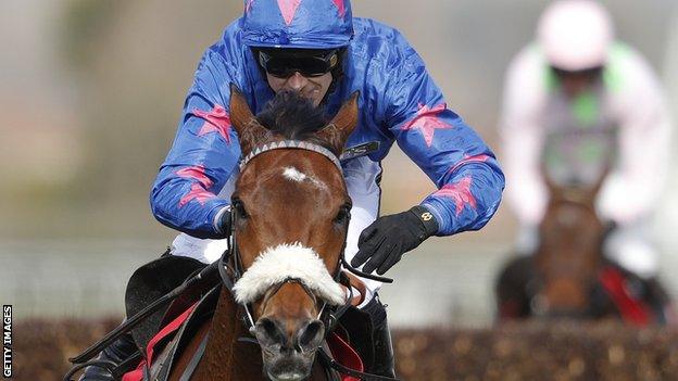 Paddy Brennan riding Cue Card to victory in the Betfred Bowl Steeple Chase at Aintree