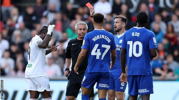 Callum Robinson is sent off by Darren Bond after throwing the ball into Ben Cabango's face