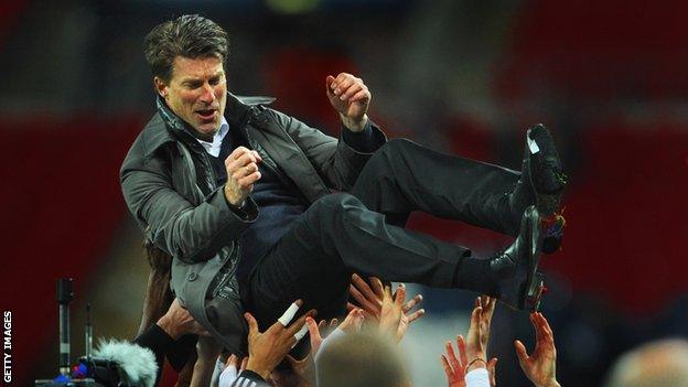 Michael Laudrup is lifted into the air by Swansea players after their 2013 Capital One Cup victory at Wembley