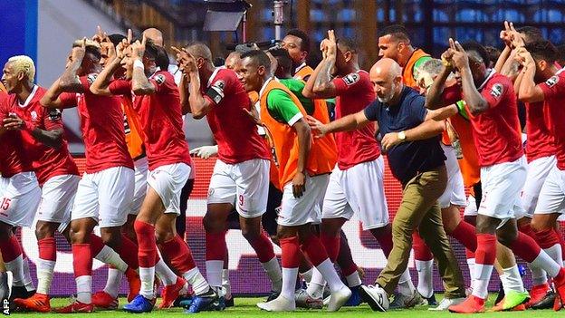 Madagascar players celebrate their second goal against Nigeria