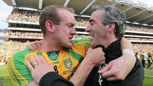 Neil Gallagher celebrates with then manager Jim McGuinness after Donegal's All-Ireland triumph in 2012