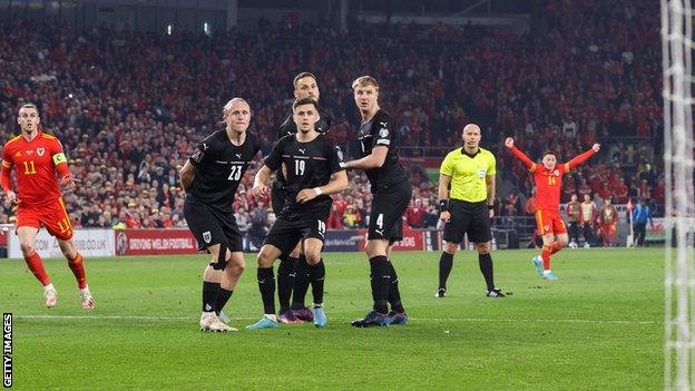 Connor Roberts (R) celebrates Gareth Bale's stunning free-kick against Austria - before the ball hits the net