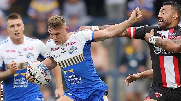 Harry Newman shrugs off a Salford Red Devils tackle