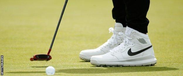 A detailed view of Jason Jason Day of Australia's footwear as he putts on the 4th green during the first round of the 146th Open Championship at Royal Birkdale on July 20, 2017