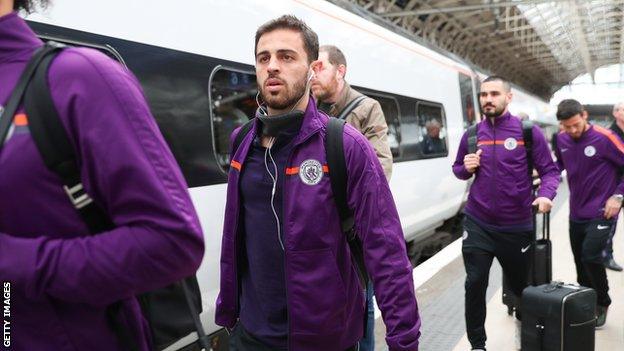 The Manchester City squad take the train from London back to Manchester