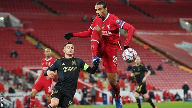 Liverpool's Joel Matip in action with Ajax's Dusan Tadic during the Champions League Group D game at Anfield