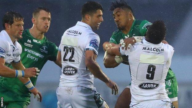 Connacht's Dundee Aki is tackled by Warriors scrum-half Ali Price in the Pro14 opener in Galway