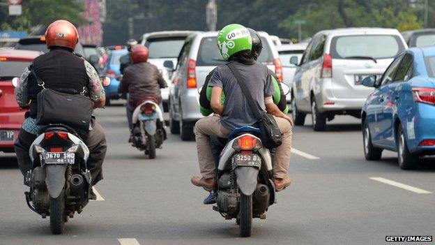 A passenger taking a ride with a Go-Jek rider