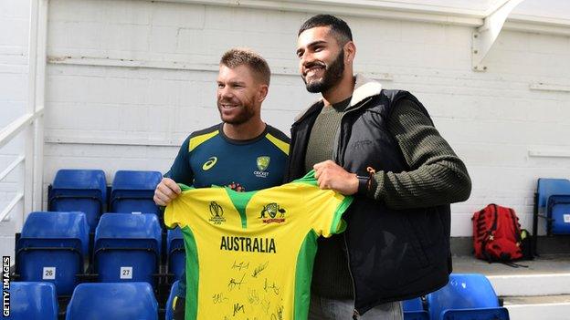 David Warner hands Jaykishan Plaha a signed Australia shirt