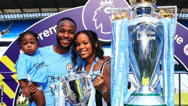 Raheem Sterling and his family pose with the Premier League trophy