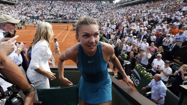 Simona Halep dashes up to her box after winning the French Open