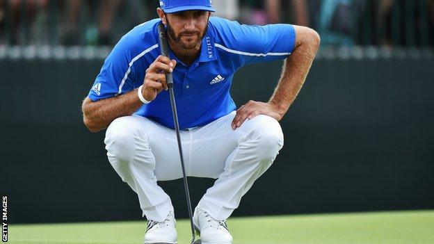 Dustin Johnson lines up a putt during the 2014 Open Championship at Hoylake