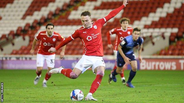 Cauley Woodrow scores a penalty for Barnsley against Wycombe