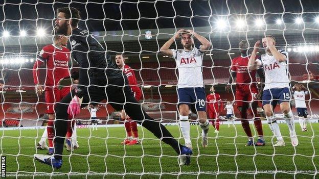 Harry Kane puts his hands on his head after missing a chance at Liverpool