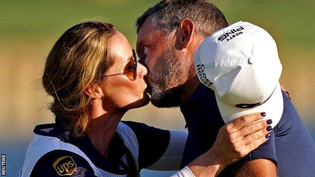 Lee Westwood and his fiancé Helen Storey kiss on the 18th green after the final round of the Players Championship