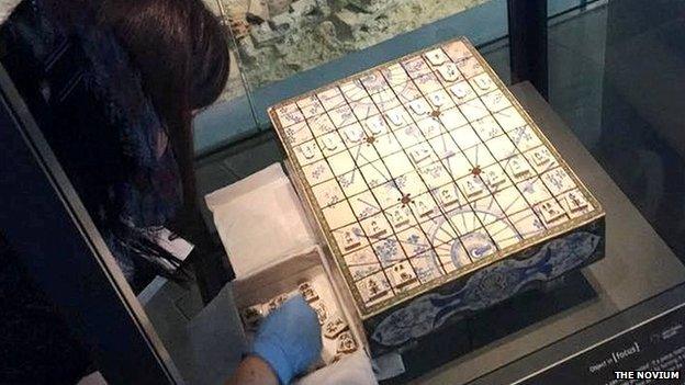 Curator installing the shogi set