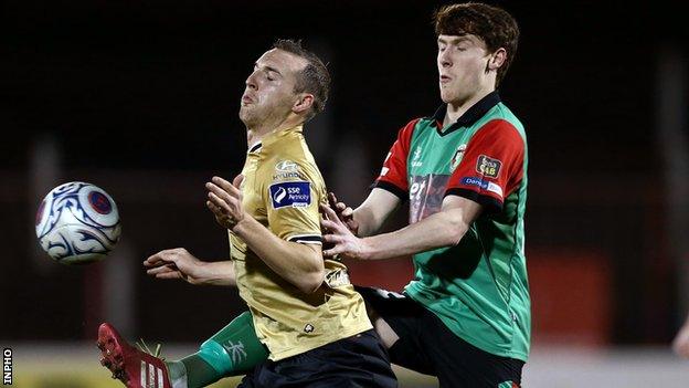 Glentoran's Willie Garrett battles with Shamrock Rovers' Karl Sheppard in a Setanta Sports Cup quarter-final in 2014