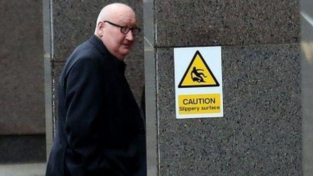 Harry Clarke arriving at an inquiry into the bin lorry crash at Glasgow Sheriff Court. He is dressed in a dark black coat or suit jacket, and is pictured entering the building.